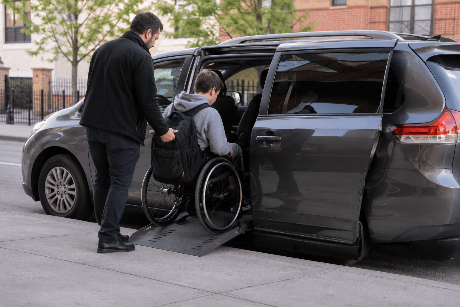 Ride Access NYC driver assisting a student in a wheelchair into an accessible van in New York City